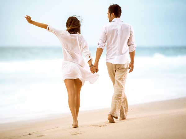 Couple walking on beach in Del Mar, CA