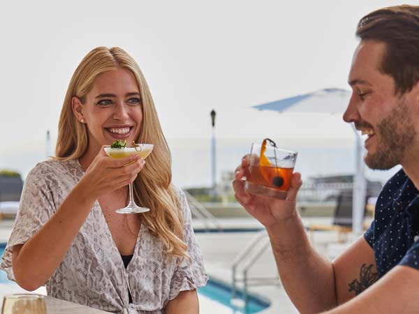 Couple Having Drinks By The Pool.