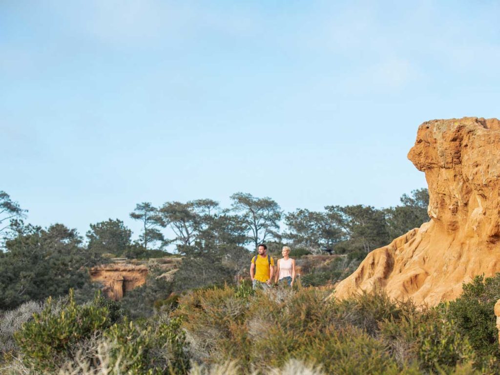 couple walking by cliff near Del Mar, CA