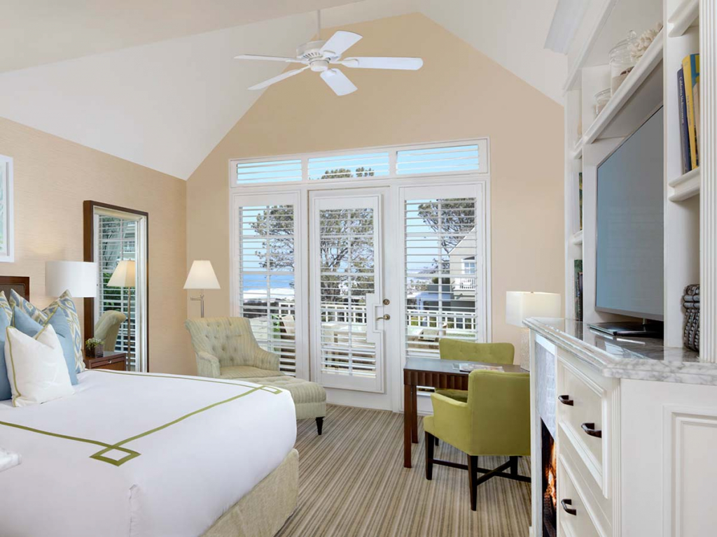 King size guestroom with patio and view of ocean