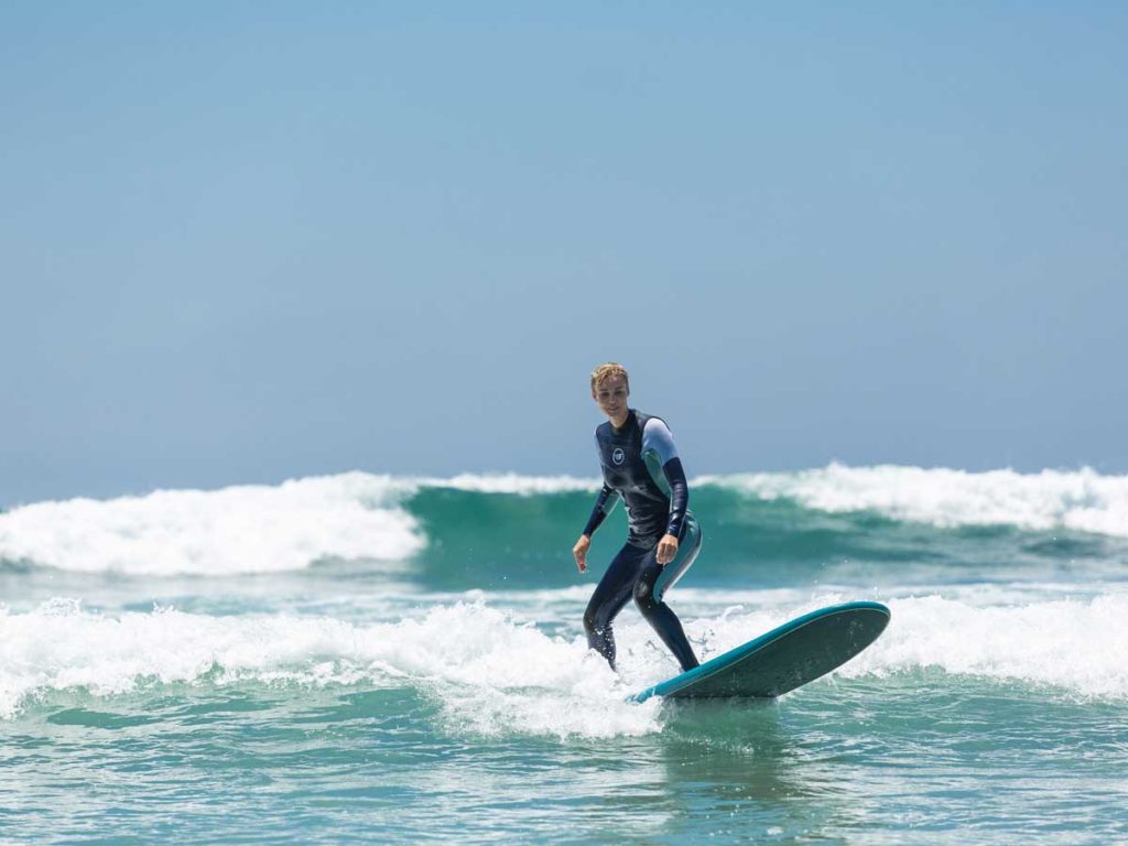 Woman surfing in Del Mar, CA