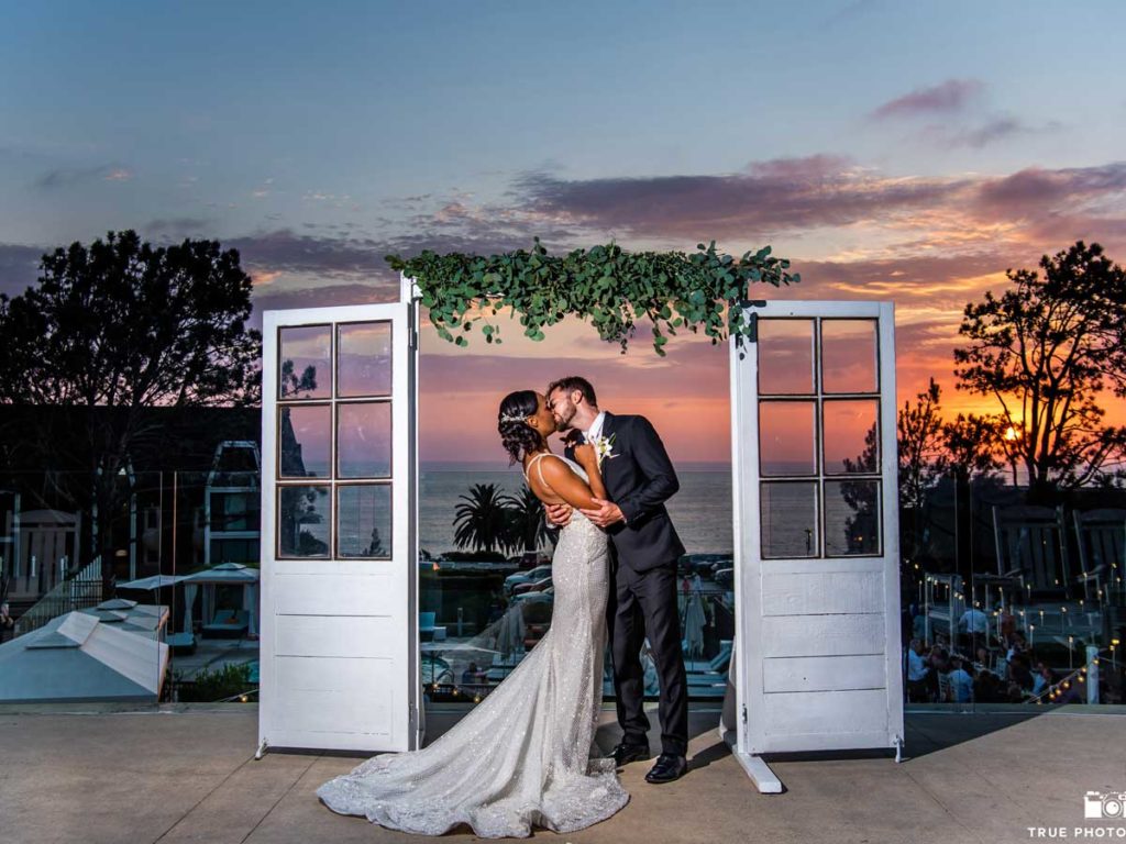 wedding couple posing for picture while kissing