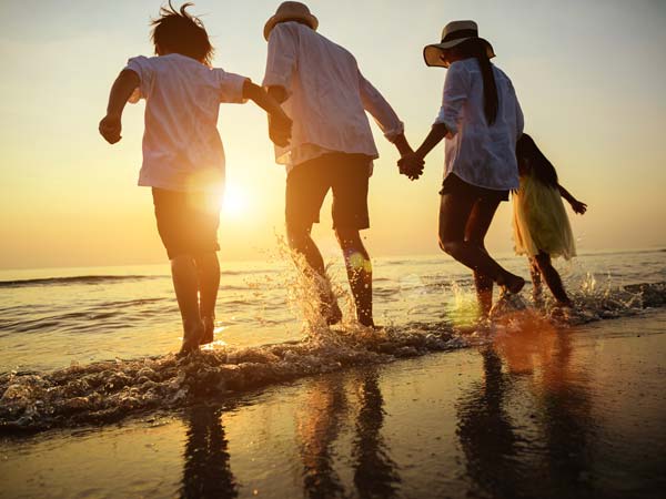 Family on the beach at sunset.