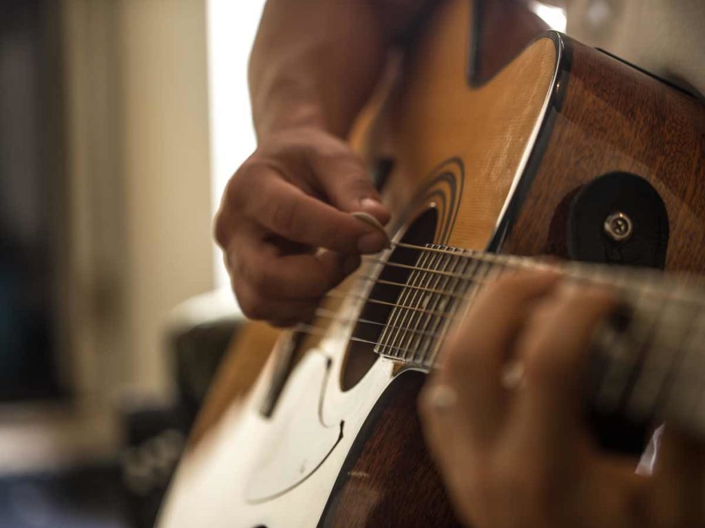 Strumming A Guitar.
