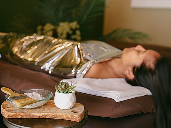 Guest relaxing during a luxurious body wrap treatment at Spa L'Auberge at L'Auberge Del Mar resort in Del Mar, California