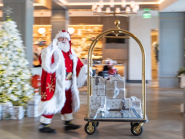 Santa Claus delivering holiday gifts on a bell cart at L'Auberge Del Mar resort